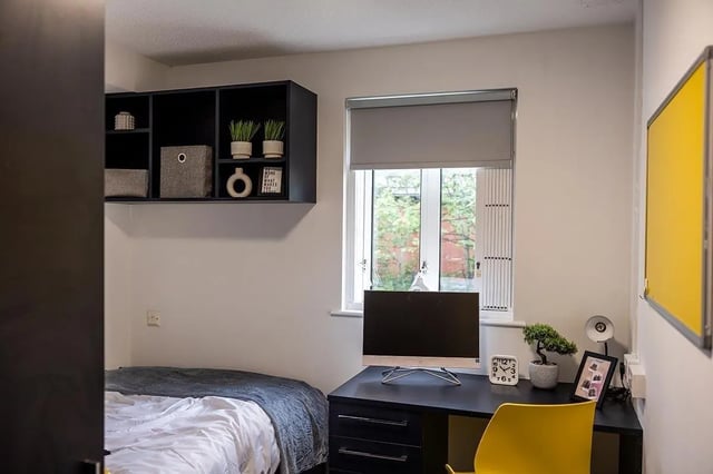 Bed desk with computer and shelves bedroom at Woodhouse Flats in Leeds Student Accommodation