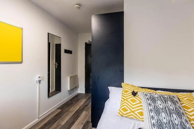 Yellow pin board mirror radiator wardrobe bedroom at Woodhouse Flats in Leeds Student Accommodation