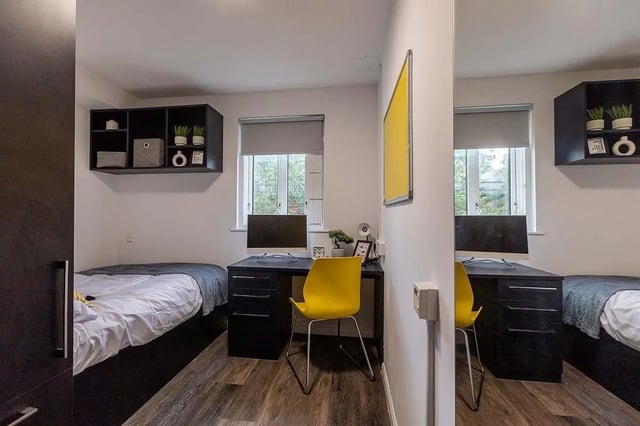 Two beds desks computers and shelves bedroom at Woodhouse Flats in Leeds Student Accommodation