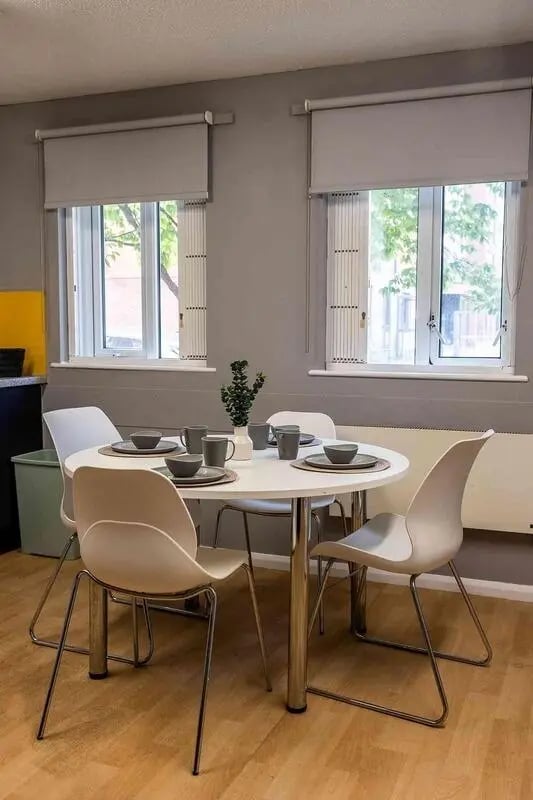 Dining table with chairs and place settings kitchen at Woodhouse Flats in Leeds Student Accommodation