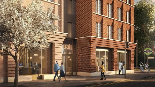 Brick building entrance with people and tree exterior at Signal House in London Student Accommodation