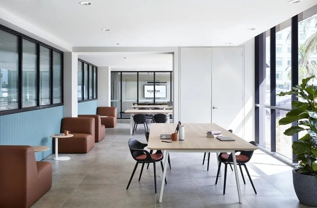Brown couches tables and chairs communal area at Campus Melbourne in Melbourne Student Accommodation