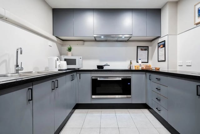 Modern grey kitchen with microwave oven and kettle kitchen at Campus Melbourne in Melbourne Student Accommodation