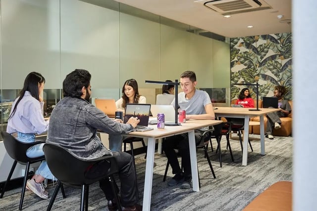 Students work on laptops at tables study area at Campus Melbourne in Melbourne Student Accommodation