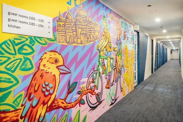 Murals hallway with doors and signage exterior at Campus Melbourne in Melbourne Student Accommodation