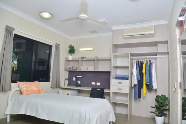 Bed desk shelves closet hanging clothes bedroom at CDU Village Casuarina in Darwin Student Accommodation