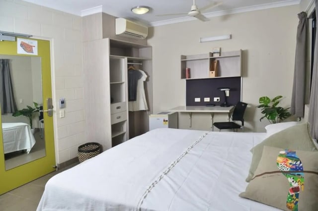 Bed desk closet and fan bedroom at CDU Village Casuarina in Darwin Student Accommodation