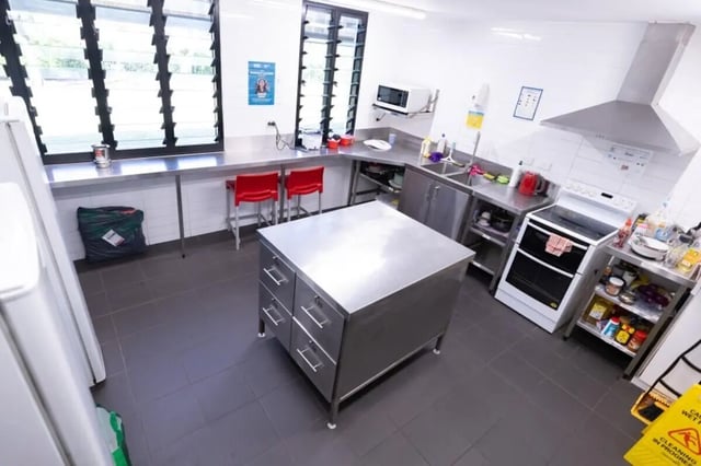 Stainless steel island with drawers and kitchen appliances kitchen at CDU Village Casuarina in Darwin Student Accommodation