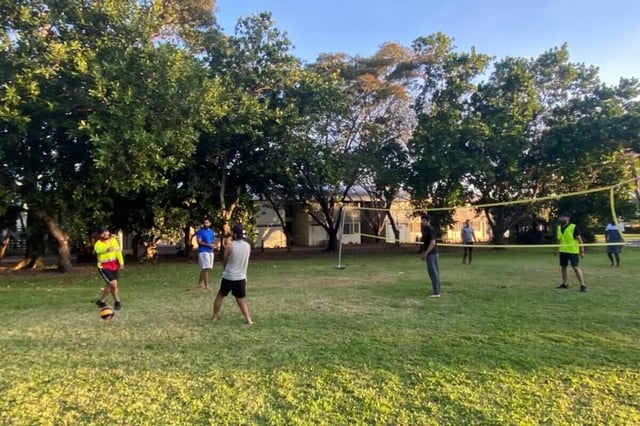 People playing volleyball on grass playing area at CDU Village Casuarina in Darwin Student Accommodation
