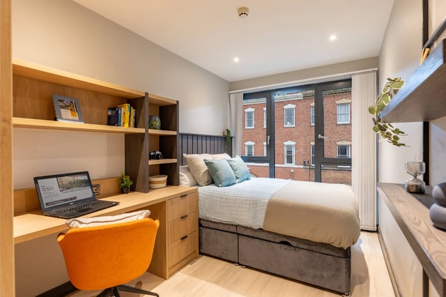 Desk bed shelving window laptop orange chair Bedroom at The Port On The Square in Bristol Student Accommodation