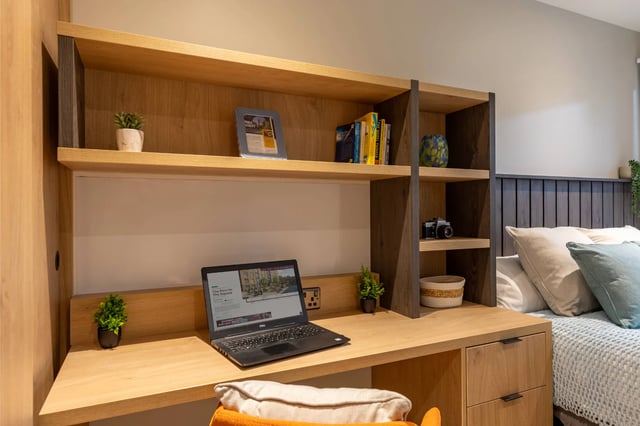 Desk with laptop shelves and bed bedroom at The Port On The Square in Bristol Student Accommodation