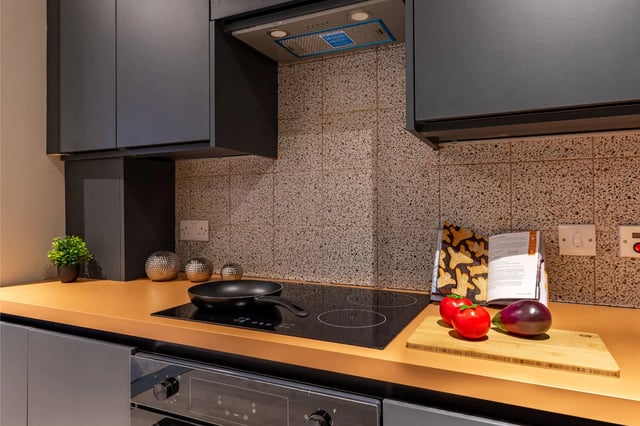 Modern kitchen with induction hob and vegetables kitchen at The Port On The Square in Bristol Student Accommodation