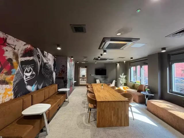 Gorilla mural long table seating living area at The Port On The Square in Bristol Student Accommodation