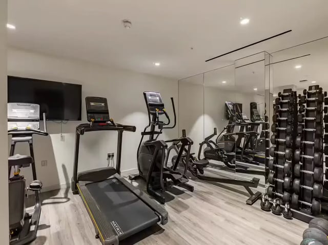 Treadmill elliptical rowing machine dumbbells gym area at Grosvenor House in London Student Accommodation