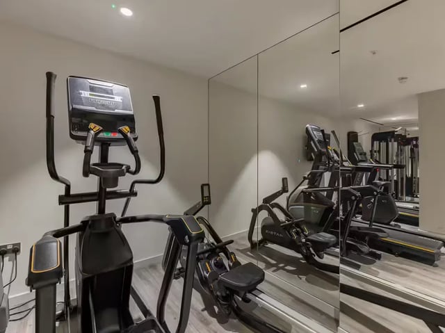 Elliptical rower and treadmills mirrored gym area at Grosvenor House in London Student Accommodation