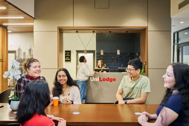 Students chatting at a reception desk common room at UniLodge Royal Melbourne in Melbourne Student Accommodation