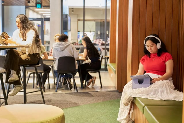 Students study at tables and on benches communal area at UniLodge Royal Melbourne in Melbourne Student Accommodation