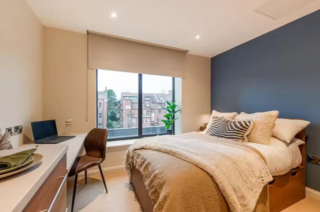 Desk laptop chair bed with pillows bedroom at Ryan Hall in Belfast Student Accommodation