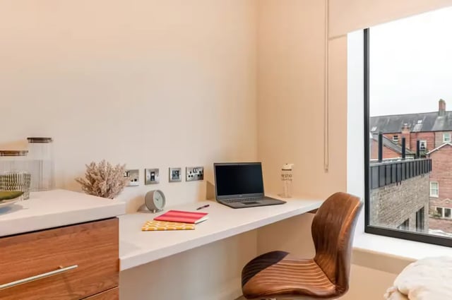 Desk with laptop notebooks chair study area at Ryan Hall in Belfast Student Accommodation