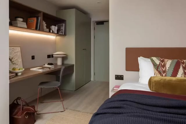 Desk chair lamp shelves books bed pillows bedroom at The Pepper Mill in Edinburgh Student Accommodation