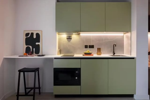 Modern kitchen with green cabinets and counter. Kitchen at The Pepper Mill in Edinburgh Student Accommodation