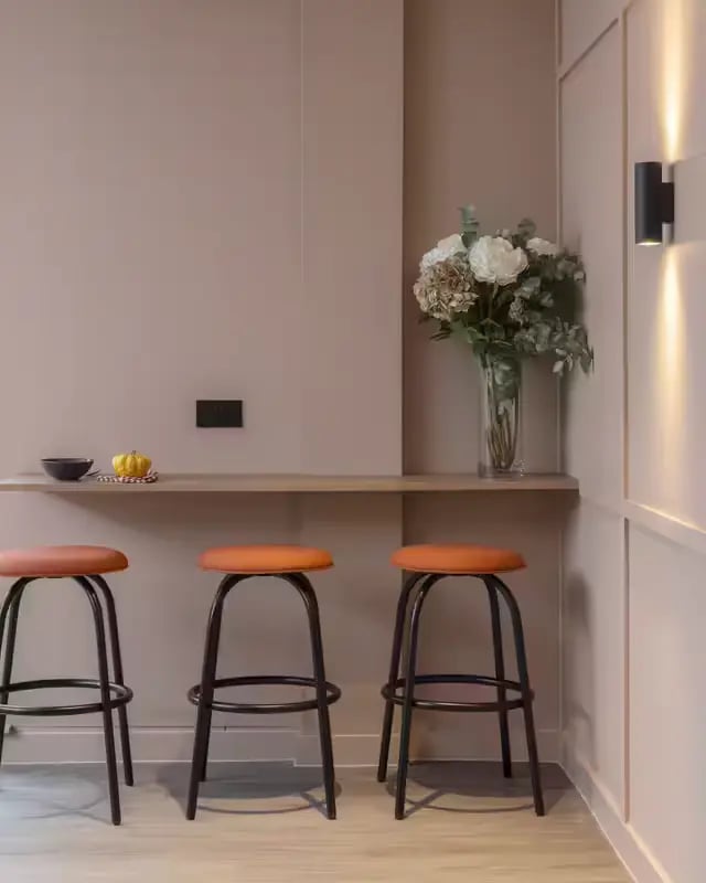 Three orange bar stools and vase kitchen area at The Pepper Mill in Edinburgh Student Accommodation