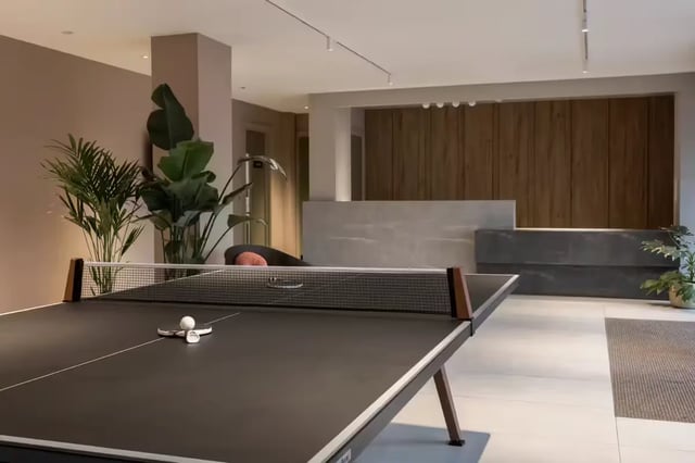 Ping pong table with plants and reception desk recreation area at The Pepper Mill in Edinburgh Student Accommodation