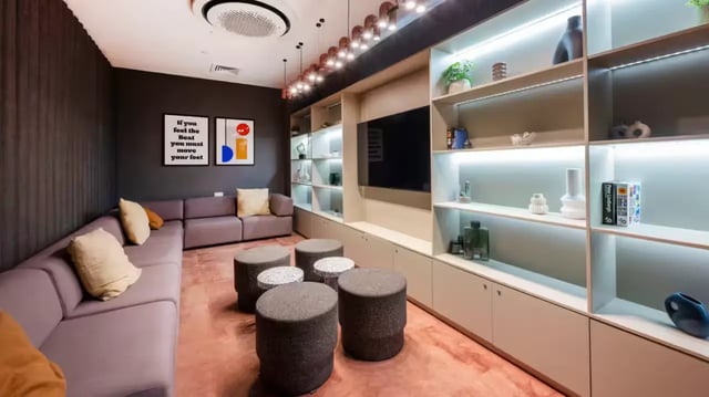 Sofa shelving and poufs in a communal lounge living room at The Aspen in Leicester Student Accommodation