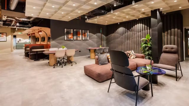 Modern communal area with sofas tables and chairs at The Aspen in Leicester Student Accommodation