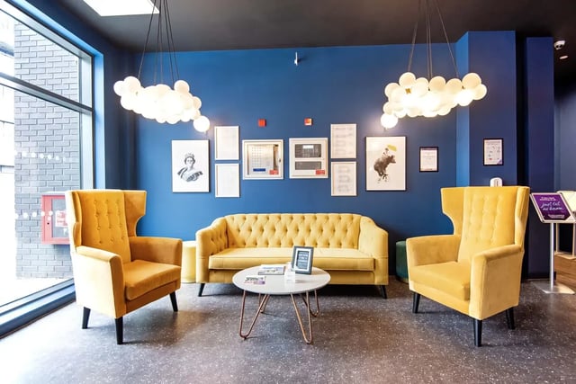Yellow chairs and sofa with artwork Living room at Howard Gardens in Cardiff Student Accommodation
