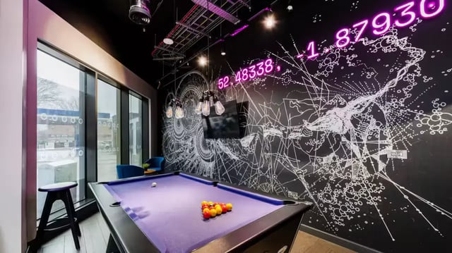 Pool table with balls and stool playing area at Compass in Birmingham Student Accommodation
