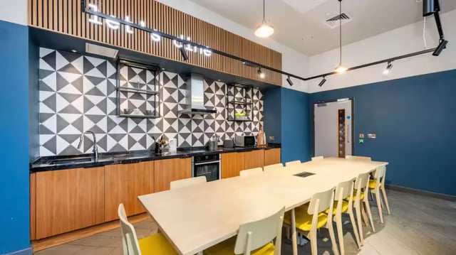 Kitchen with counter sink cabinets and long table kitchen at Compass in Birmingham Student Accommodation