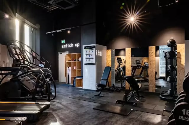 Gym equipment exercise machines dumbbells lockers playing area at Compass in Birmingham Student Accommodation