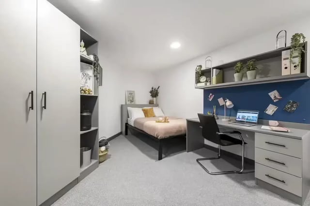 Wardrobe shelves bed desk chair and laptop bedroom at Compass in Birmingham Student Accommodation