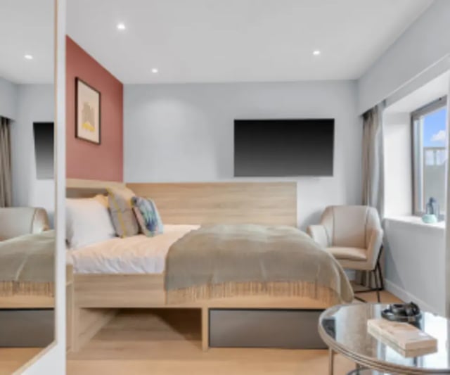Bed TV chair and mirror bedroom at Iconinc The Bonnie in Glasgow Student Accommodation
