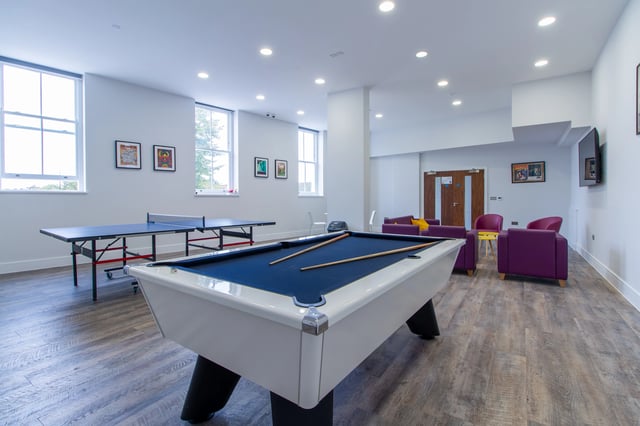 Pool table ping pong table purple chairs living area at AXO Seven Sisters in London Student Accommodation