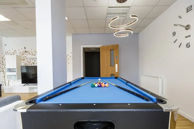 Pool table with cues and balls recreation area at AXO Islington in London Student Accommodation