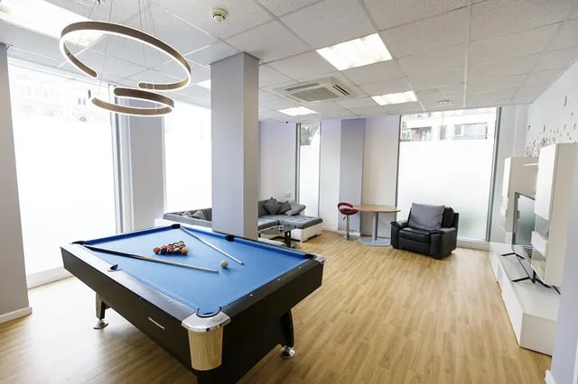 Pool table sofas chairs and TV living room at AXO Islington in London Student Accommodation
