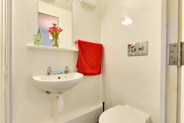 Sink toiletries red towel toilet cistern bathroom at AXO Islington in London Student Accommodation