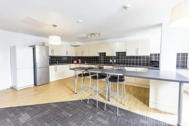 Kitchen with counter and stools kitchen area at AXO Islington in London Student Accommodation