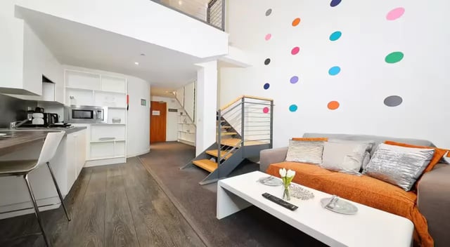 Kitchen living area with colorful dots staircase living area at Gallery Apartments in Glasgow Student Accommodation