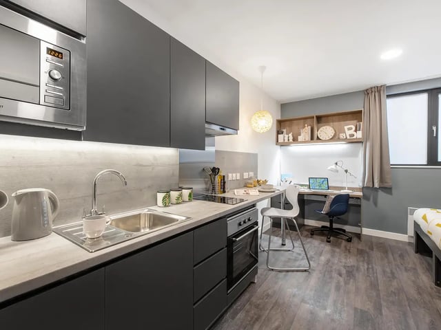 Modern kitchen with desk and bed studio apartment at Yugo Bailey Point in Bournemouth Student Accommodation