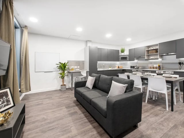 Sofa dining table kitchen cabinets whiteboard living kitchen at Yugo Bailey Point in Bournemouth Student Accommodation
