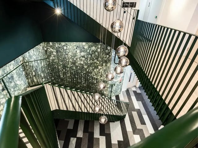 Modern staircase with pendant lights and terrazzo walls Staircase at Promenade Student Living in Brighton Student Accommodation