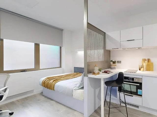 Bed kitchen area with bar stool and oven at Promenade Student Living in Brighton Student Accommodation