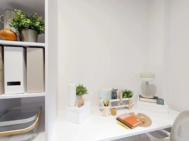 Desk with lamp notebooks and supplies study area at Promenade Student Living in Brighton Student Accommodation