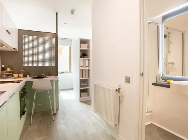 Kitchen with bar and bathroom beyond. at Promenade Student Living in Brighton Student Accommodation
