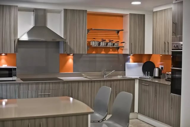 Modern kitchen with grey cabinets and orange backsplash kitchen at Friargate Court in Preston Student Accommodation