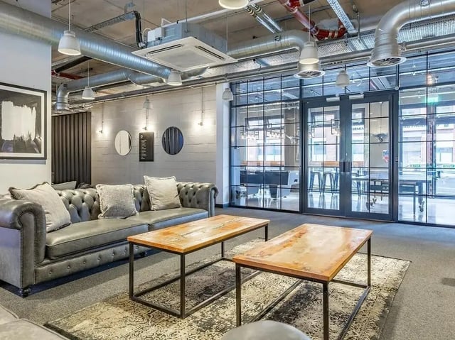 Chesterfield sofa coffee tables patterned rug living room at Globe Works in Birmingham Student Accommodation