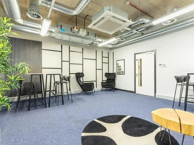 High bar table chairs black armchairs sitting area living room at Globe Works in Birmingham Student Accommodation